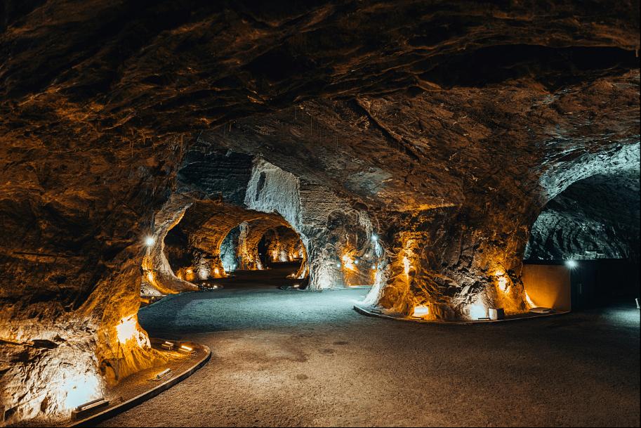 Illuminated cave in Slovak Karst – underground rock corridors with colorful lights